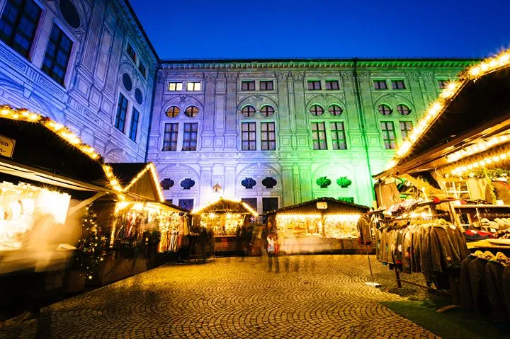 Christmas market at night with illuminated stalls