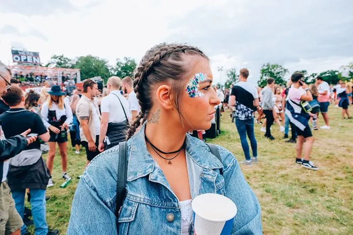 Festival goer with face glitter at an outdoor music event
